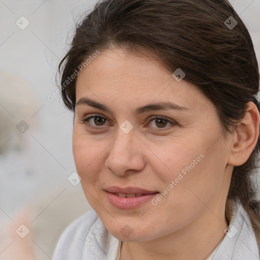 Joyful white adult female with medium  brown hair and brown eyes