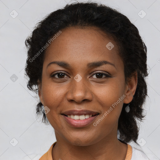 Joyful black young-adult female with long  brown hair and brown eyes