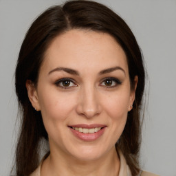 Joyful white young-adult female with medium  brown hair and brown eyes