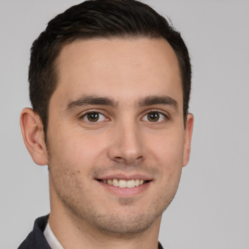 Joyful white young-adult male with short  brown hair and brown eyes