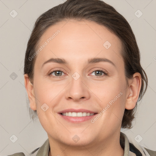 Joyful white young-adult female with medium  brown hair and grey eyes