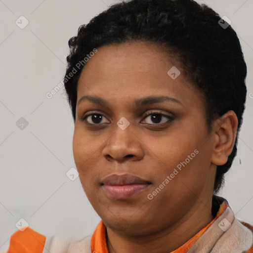Joyful black young-adult female with short  black hair and brown eyes