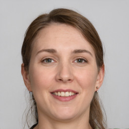 Joyful white adult female with medium  brown hair and grey eyes