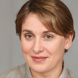 Joyful white adult female with medium  brown hair and grey eyes