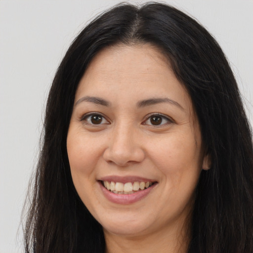 Joyful asian young-adult female with long  brown hair and brown eyes