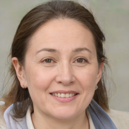 Joyful white adult female with medium  brown hair and brown eyes