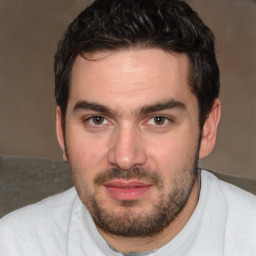 Joyful white young-adult male with short  black hair and brown eyes