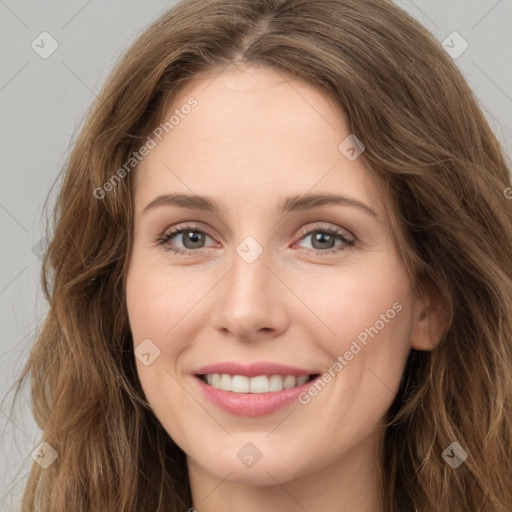 Joyful white young-adult female with long  brown hair and green eyes