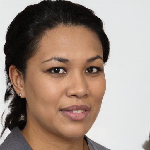 Joyful latino young-adult female with medium  black hair and brown eyes
