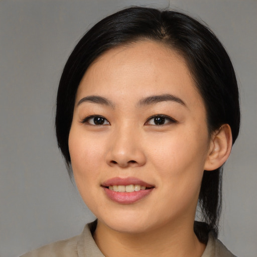 Joyful asian young-adult female with medium  black hair and brown eyes