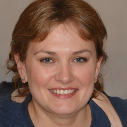 Joyful white young-adult female with medium  brown hair and blue eyes