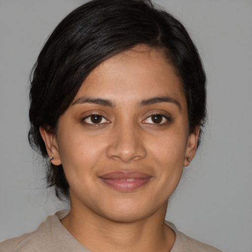 Joyful latino young-adult female with medium  black hair and brown eyes