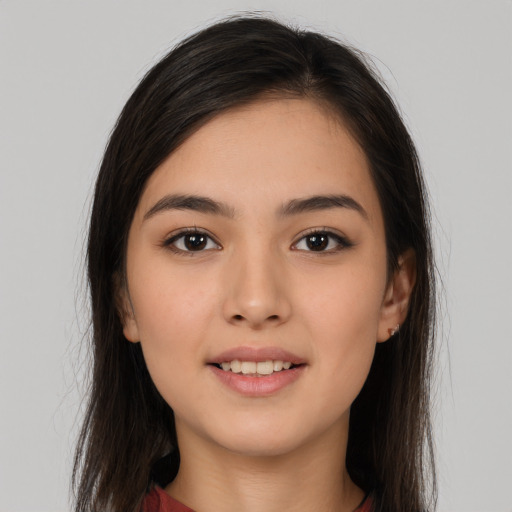 Joyful white young-adult female with long  brown hair and brown eyes
