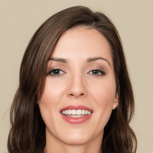 Joyful white young-adult female with long  brown hair and brown eyes