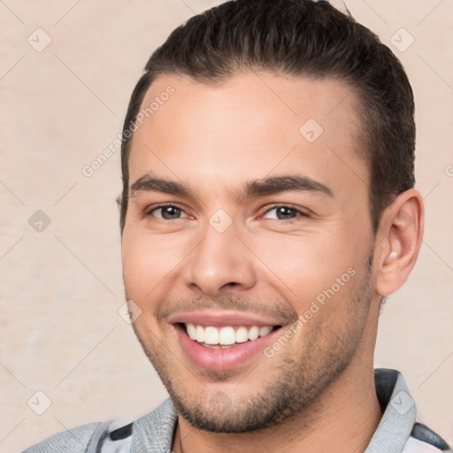 Joyful white young-adult male with short  brown hair and brown eyes