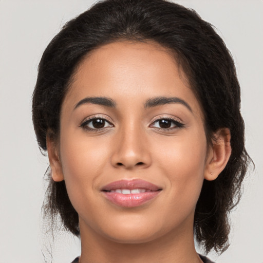 Joyful latino young-adult female with medium  brown hair and brown eyes