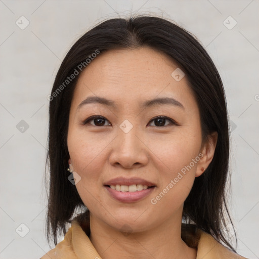 Joyful asian adult female with medium  brown hair and brown eyes