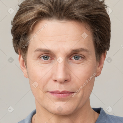 Joyful white adult male with short  brown hair and grey eyes