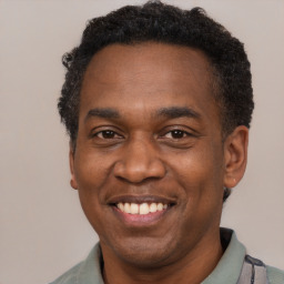 Joyful latino adult male with short  black hair and brown eyes