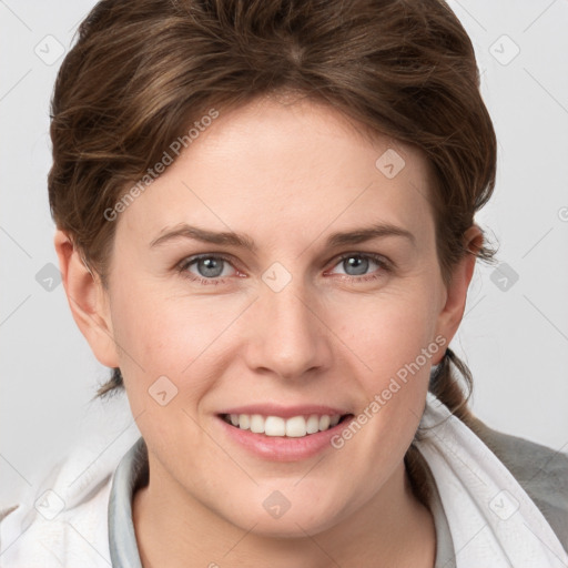 Joyful white young-adult female with medium  brown hair and grey eyes