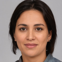 Joyful white adult female with medium  brown hair and brown eyes