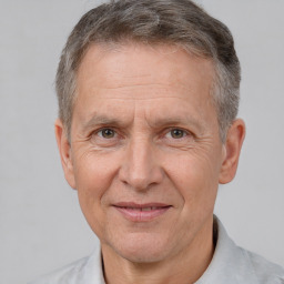 Joyful white middle-aged male with short  brown hair and brown eyes