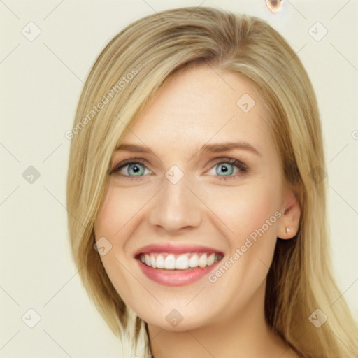 Joyful white young-adult female with long  blond hair and blue eyes