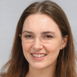 Joyful white adult female with long  brown hair and brown eyes