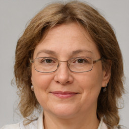 Joyful white adult female with medium  brown hair and blue eyes