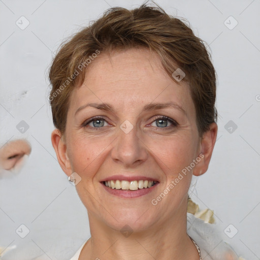 Joyful white adult female with short  brown hair and grey eyes