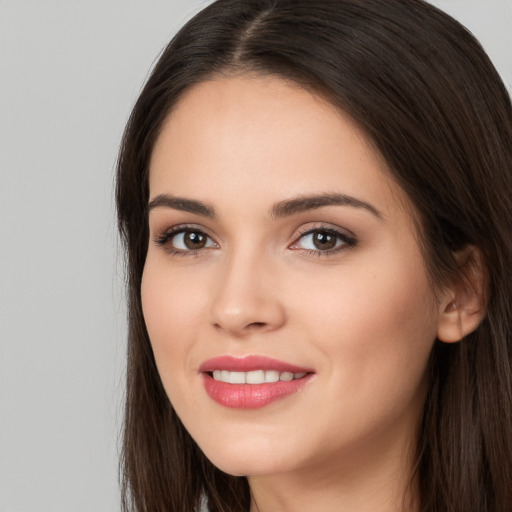 Joyful white young-adult female with long  brown hair and brown eyes