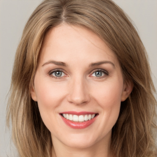 Joyful white young-adult female with long  brown hair and green eyes