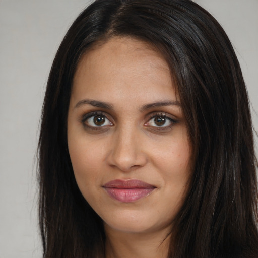 Joyful white young-adult female with long  brown hair and brown eyes