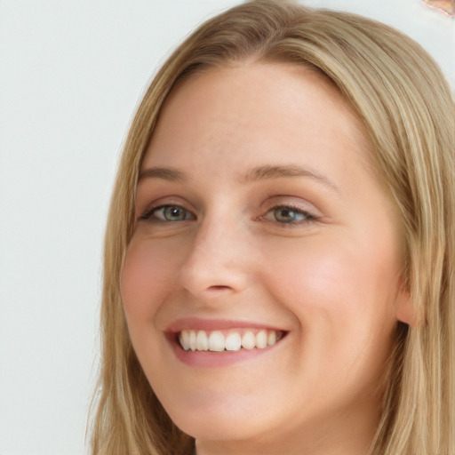 Joyful white young-adult female with long  brown hair and blue eyes