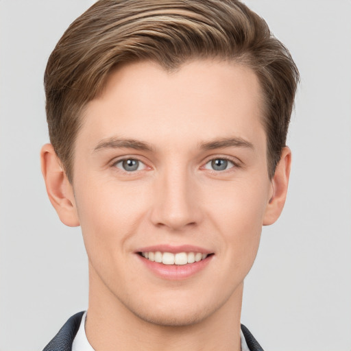 Joyful white young-adult male with short  brown hair and grey eyes