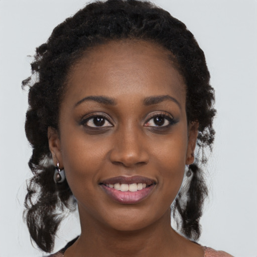 Joyful black young-adult female with medium  black hair and brown eyes