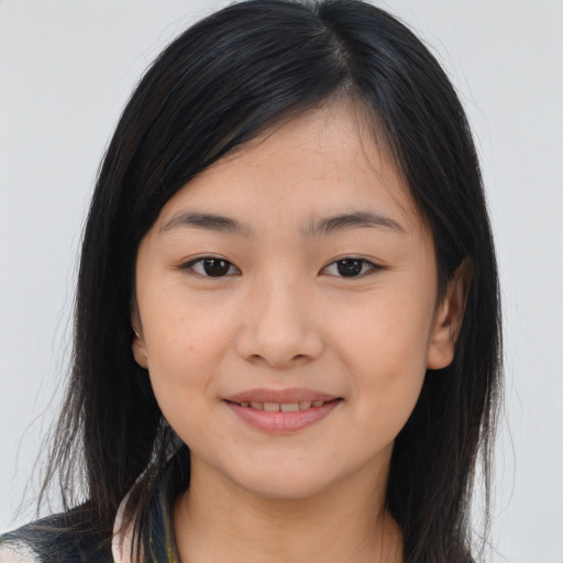 Joyful asian young-adult female with long  brown hair and brown eyes