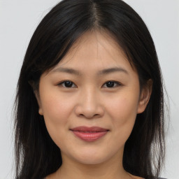 Joyful asian young-adult female with long  brown hair and brown eyes