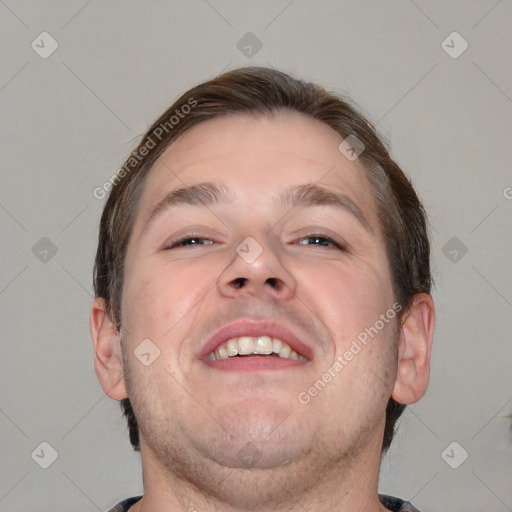 Joyful white adult male with short  brown hair and grey eyes