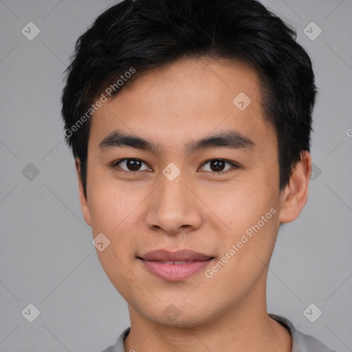 Joyful asian young-adult male with short  black hair and brown eyes