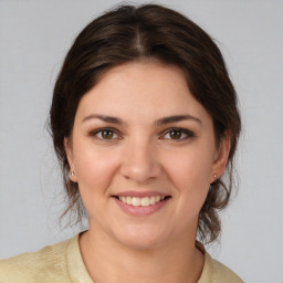 Joyful white young-adult female with medium  brown hair and brown eyes