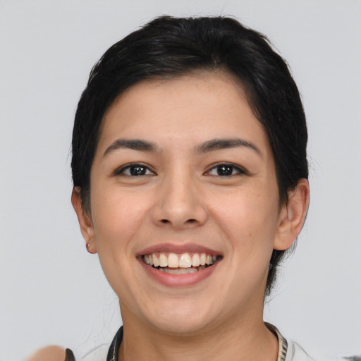 Joyful white young-adult female with short  black hair and brown eyes