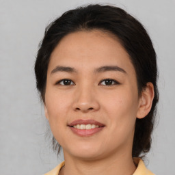 Joyful asian young-adult female with medium  brown hair and brown eyes