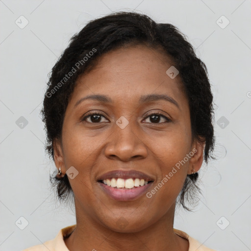 Joyful black adult female with long  brown hair and brown eyes