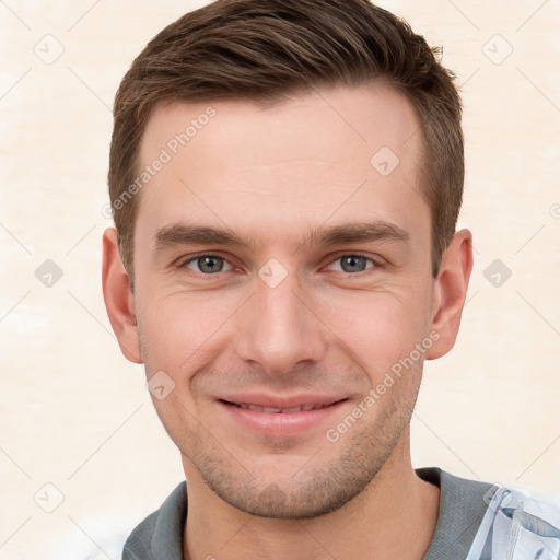 Joyful white young-adult male with short  brown hair and grey eyes