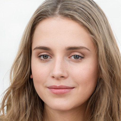 Joyful white young-adult female with long  brown hair and green eyes