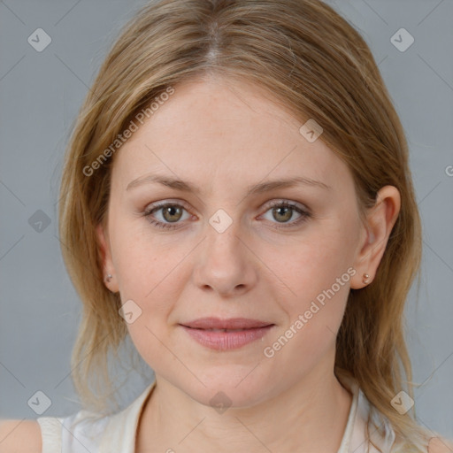 Joyful white young-adult female with medium  brown hair and blue eyes