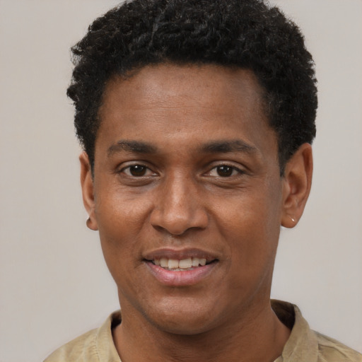 Joyful black young-adult male with short  black hair and brown eyes