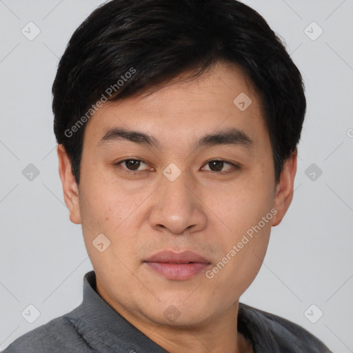 Joyful asian young-adult male with short  black hair and brown eyes