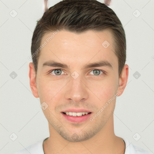 Joyful white young-adult male with short  brown hair and grey eyes